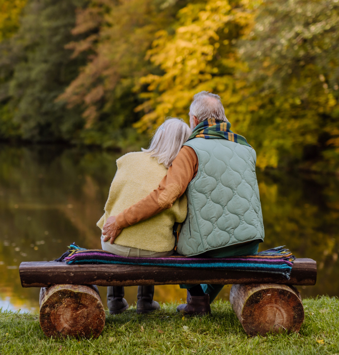 Couple relaxing on a bench by the lake